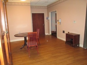 This was where board meetings were held. The door leads into the hallway. JJ's room is through the doorway at the right. 