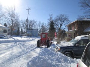 Our neighbor plowing near our stone wall where we often park.