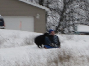 I think my camera got wet because it was blurry for a bit, but this is Danny jumping on JJ as he tries to sled down the hill.
