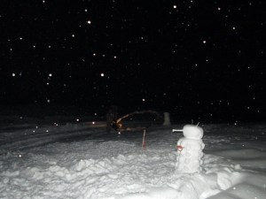 EJ snowblowing the driveway in the dark. 
